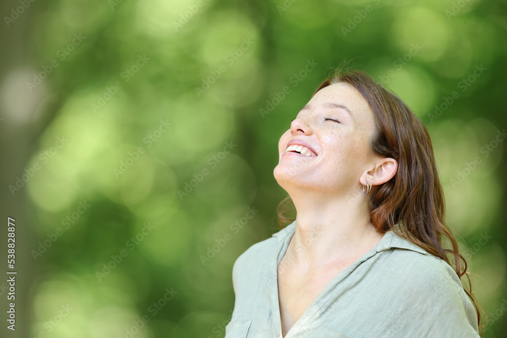 Happy woman breathing and smiling in the mountain Happy woman breathing and smiling in the mountain