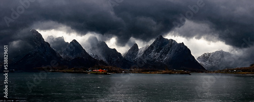 dark clouds over a fjord landscape