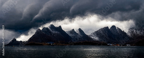 dark clouds over a fjord landscape