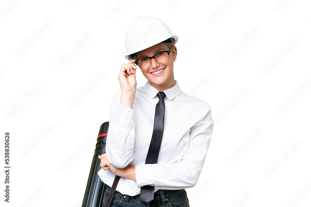Young architect caucasian woman with helmet and holding blueprints over isolated background with glasses and happy Young architect caucasian woman with helmet and holding blueprints over isolated background with glasses and happy