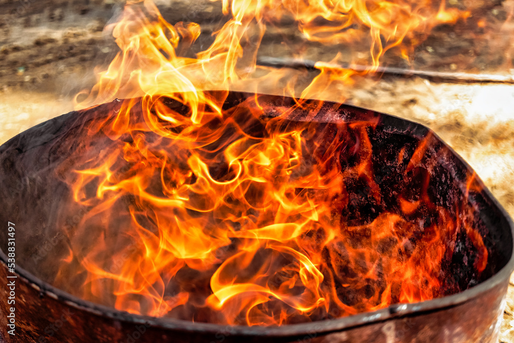 Burning fire in a barrel close-up. Bright flame. Open flame heating. Problems with heating and gas. Burning fire in a barrel close-up. Bright flame. Open flame heating. Problems with heating and gas.