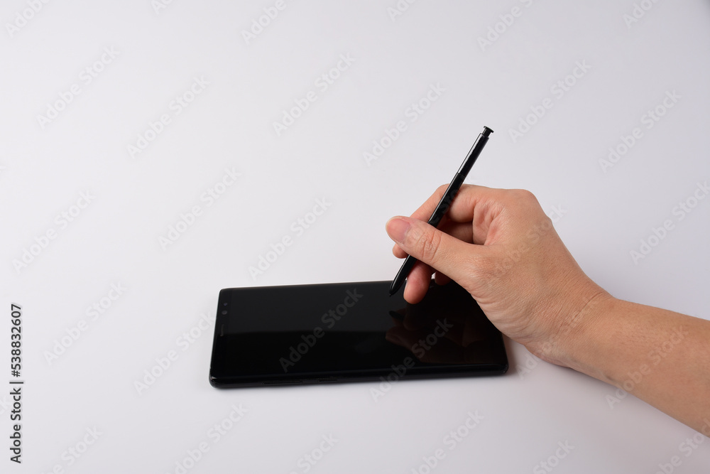 Hand and smartphone and black stylus for writing isolated on white background. Hand and smartphone and black stylus for writing isolated on white background.