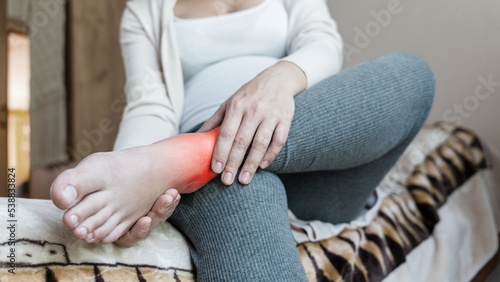 Pregnancy foot ankle pain. Pregnant woman have leg disease, ankle pain doing health massage exercise. Leg cramps during pregnancy.