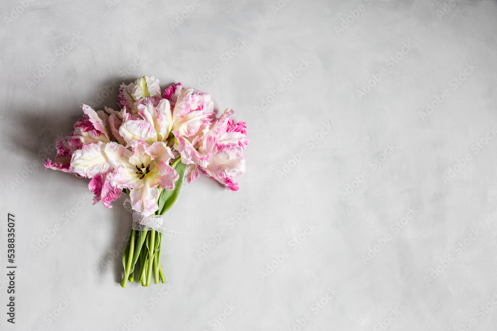 Bouquet of pink blooming Silver Parrot tulips lying against white background Bouquet of pink blooming Silver Parrot tulips lying against white background