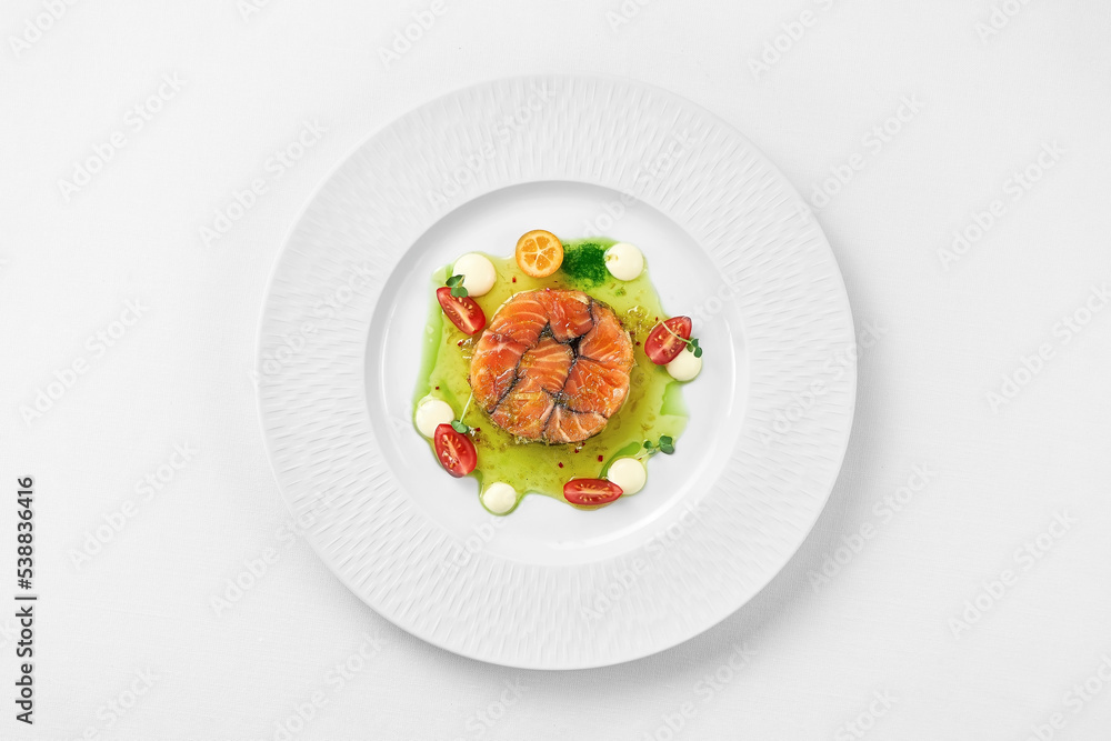 Salmon sous vide with spices in a white plate on a white background. Close-up, selective focus. Salmon sous vide with spices in a white plate on a white background. Close-up, selective focus.