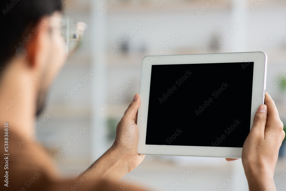 Unrecognizable young man holding digital tablet, mockup