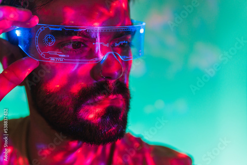 Man with beard wearing futuristic smart glasses photo