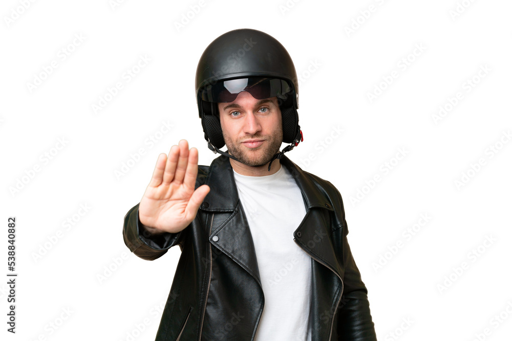 Young caucasian man with a motorcycle helmet isolated on green chroma background making stop gesture Young caucasian man with a motorcycle helmet isolated on green chroma background making stop gesture