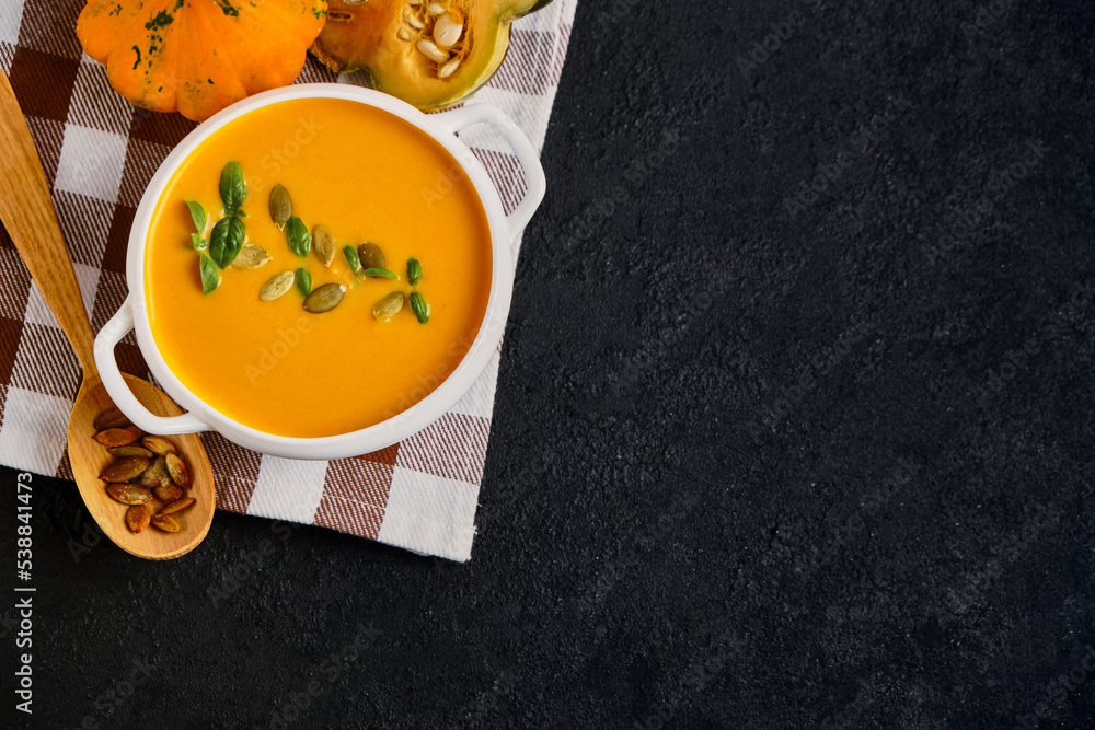 Pumpkin cream soup with pumpkin seeds served Pumpkin cream soup with pumpkin seeds served