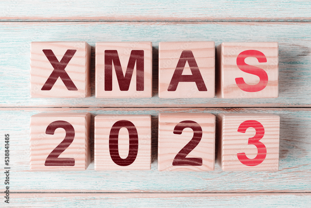Wooden cubes with caption Xmas 2023. Christmas and New Year greeting card Wooden cubes with caption Xmas 2023. Christmas and New Year greeting card
