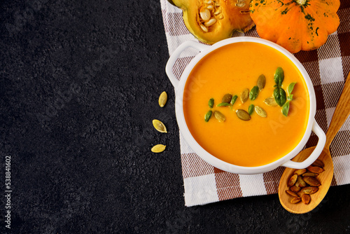 Pumpkin cream soup with pumpkin seeds served