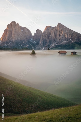 Konstfotografi Vertical view of a beautiful sunrise on snowy hills and rocks with mist in South