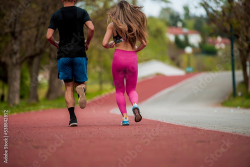 Young couple jogging in park at morning Health and fitness