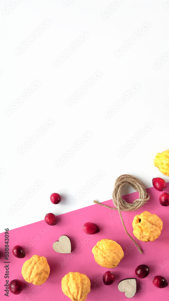 Autumn decorative orange border with yellow quince fruit, magenta cranberries, hemp cord and wooden hearts. Vibrant Fall decor with copy-space. Backdrop, flat lay, top view, stories for social media. Autumn decorative orange border with yellow quince fruit, magenta cranberries, hemp cord and wooden hearts. Vibrant Fall decor with copy-space. Backdrop, flat lay, top view, stories for social media.