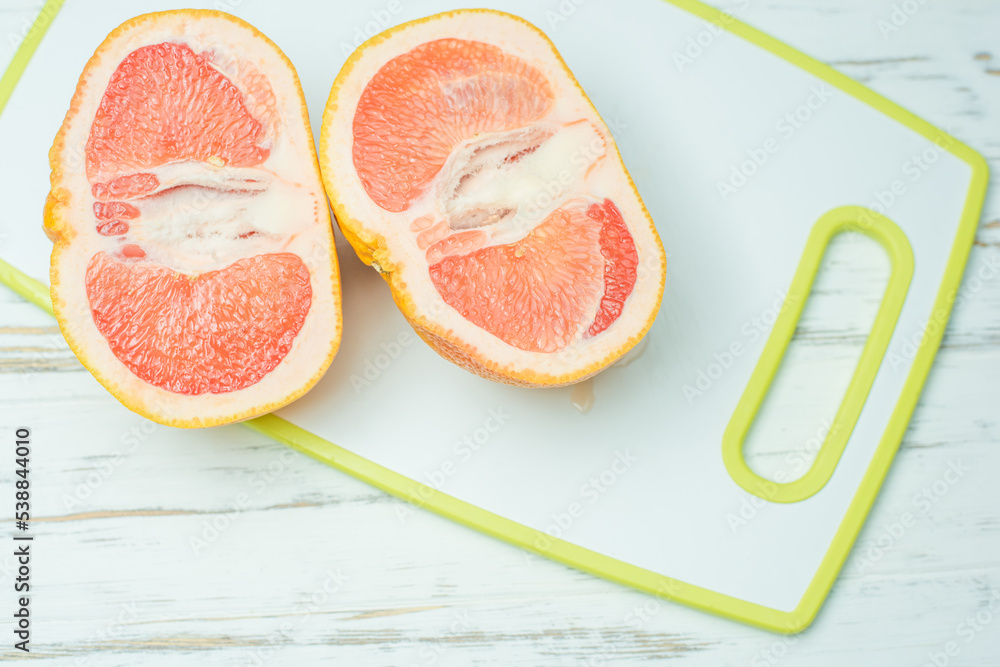 grapefruit banana, woman's hand grapefruit banana, woman's hand