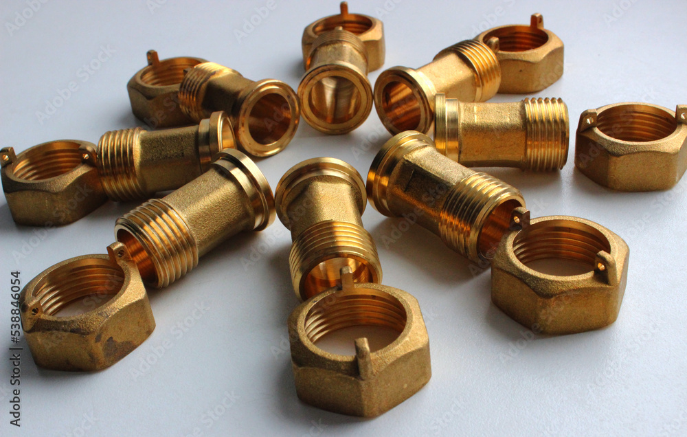 Male Brass Water Meter Fittings And Union Nuts Laid Out In The Form Of Flower On White Surface
Male Brass Water Meter Fittings And Union Nuts Laid Out In The Form Of Flower On White Surface