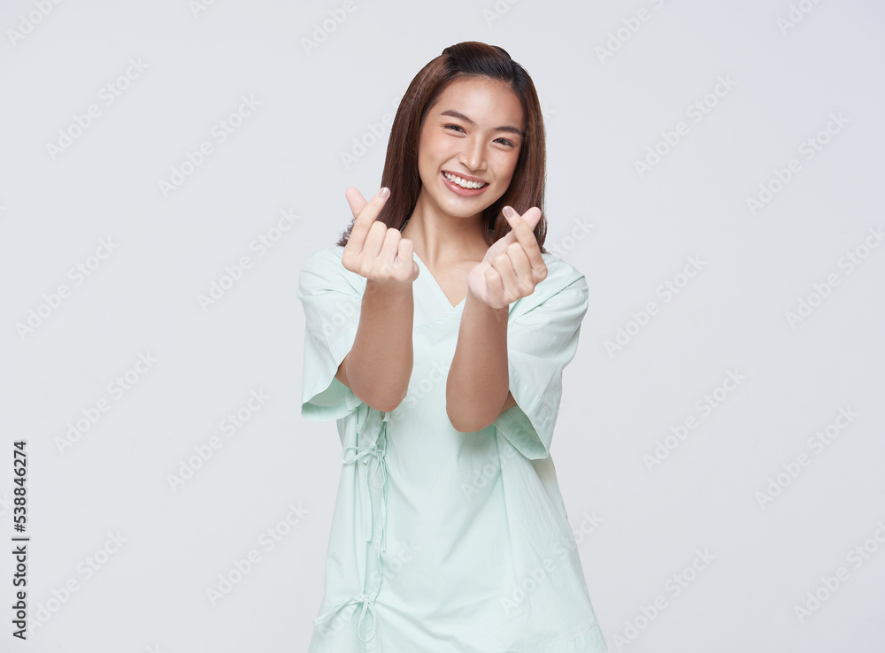 Happy asian woman patient showing heart isolated on white background. life insurance concept. Happy asian woman patient showing heart isolated on white background. life insurance concept.