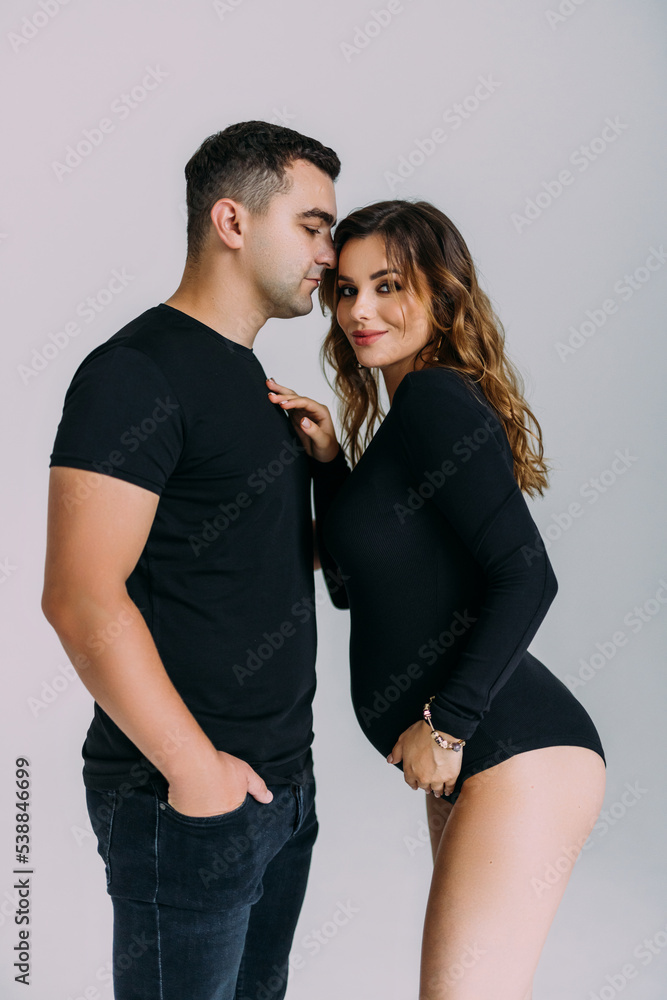 Happy pregnant couple looking to the future on white background Happy pregnant couple looking to the future on white background