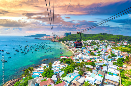 The longest cable car ride in the world, Phu Quoc island in South Vietnam, sunset sky. Below is traditional fishermen boats lined in the harbor of An Thoi town in the popular Hon Thom island. 