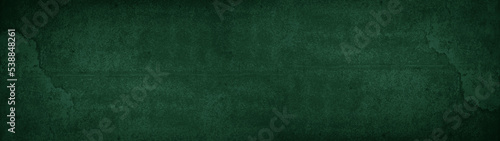 Abstract grunge spotted old aged retro antique dark green colored stone concrete paper texture background panorama banner, long pattern backgrounds.
