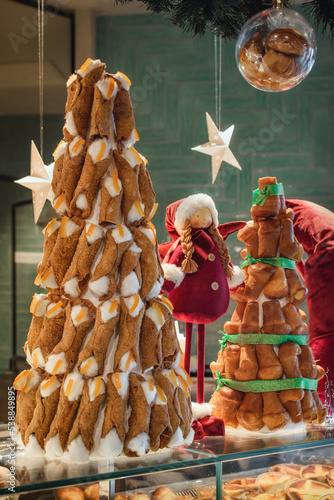 Nice christmas tree made vith sicilian cannoli, typical sweet italian food filled with cheese and candied oranges