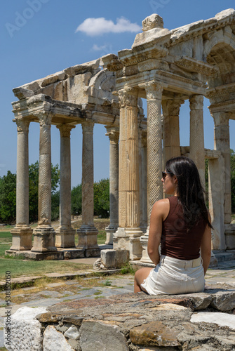 Unrecognizable young tourist woman in the ancient ruins of Aphrodisia, Turkey