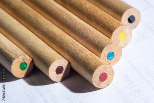 group of colored wooden pencils for freehand drawing on white background