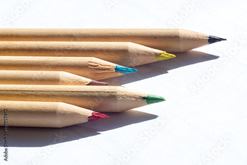 group of colored wooden pencils for freehand drawing on white background