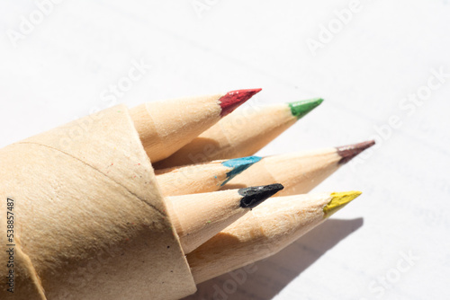group of colored wooden pencils for freehand drawing on white background