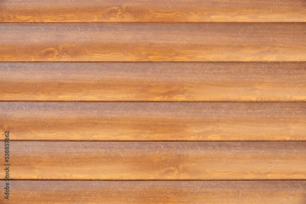 Fototapeta premium Facade cladding from solid wood handmade boards in brown color