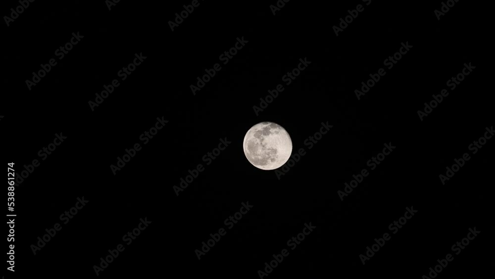 Large full moon moves across the sky.Clouds passing by moon at night. Full moon at night , India Large full moon moves across the sky.Clouds passing by moon at night. Full moon at night , India