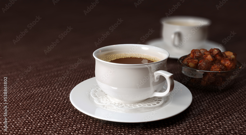 Fototapeta premium Two white cups of coffee on brown table.
