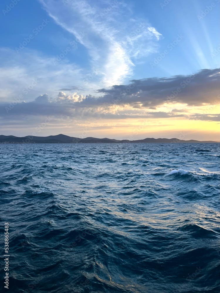 Sunset at the sea, sea horizon, sun rays through the clouds Sunset at the sea, sea horizon, sun rays through the clouds