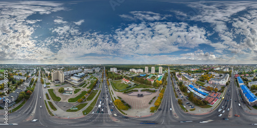 aerial full seamless spherical hdri 360 panorama view above road junction with traffic in city overlooking of residential area of high-rise buildings in equirectangular projection.