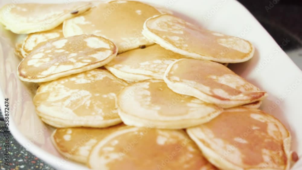 Freshly made small pancakes on a kefir base. Freshly made small pancakes on a kefir base.
