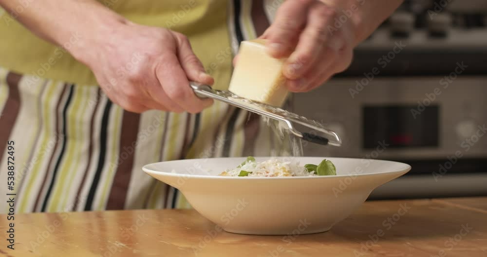 Male home cook serving fresh spinach and ricotta ravioli in his kitchen. Closeup shot. Male home cook serving fresh spinach and ricotta ravioli in his kitchen. Closeup shot.