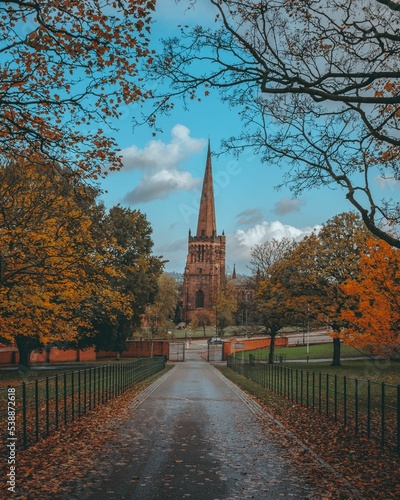 Beautiful display of the Aston Parish Church surrounded by autumn foliage, great for background photo
