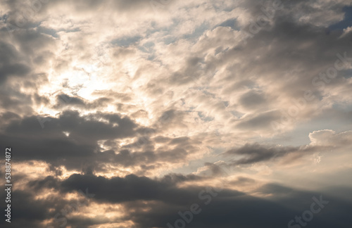 Dramatic cloudy sky and sun rays during a beautiful autumn morning on top of the mountains.