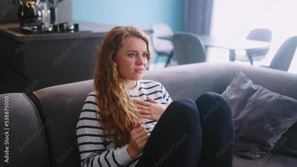Sadfemale suffer breaking up, relationship problems with boyfriend, divorce with husband, feeling heartache sitting on sofa with smartphone. Girl with unhappy expression overthinking after quarrel. Sadfemale suffer breaking up, relationship problems with boyfriend, divorce with husband, feeling heartache sitting on sofa with smartphone. Girl with unhappy expression overthinking after quarrel.