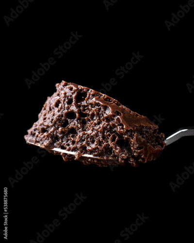 Spoonful of chocolate mousse with dark background
