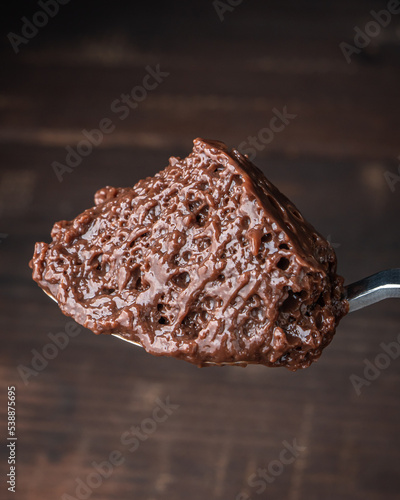 Spoonful of chocolate mousse with dark background