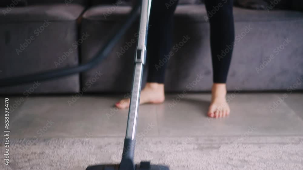 Video Stock Caucasian woman has a heart attack vacuuming floor in her