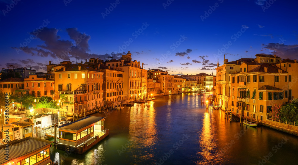 Night panorama of the Grand Canal filled with lights in Venice, Italy. Summer holidays. Travel concept background.