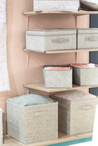 Organizing home storage. Organization of home space. Storage of things in the dressing room on the shelves in textile baskets and boxes