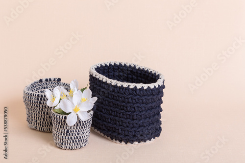 Hobbies and creativity, crochet. Knitted basket organizers handmade from natural cotton for storing things, for cosmetics and personal accessories, interior decor and organizing home space and comfort