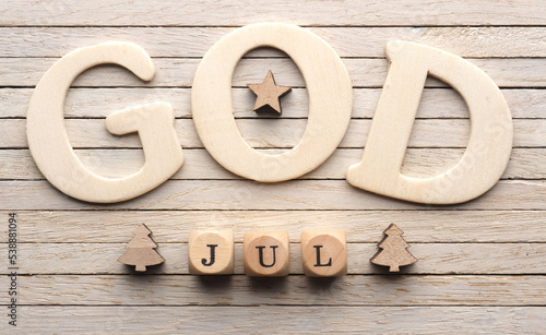 God Jul, Scandinavian Merry Christmas, Small wooden blocks and wooden letters on a wooden background