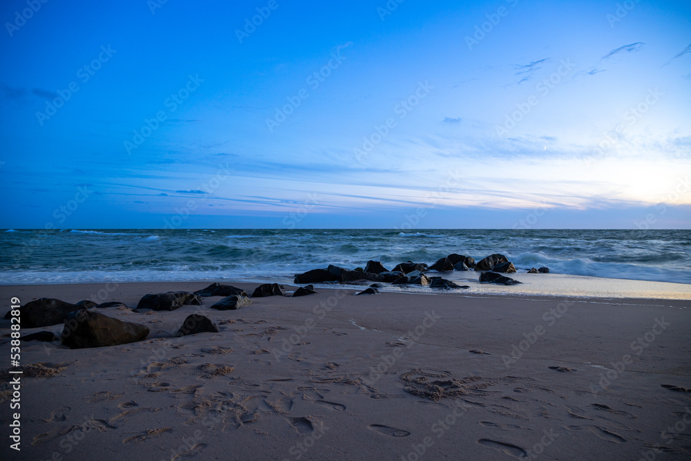 Long exposure by the sea with rocks in the sand, blue hour. Denmark beach Long exposure by the sea with rocks in the sand, blue hour. Denmark beach