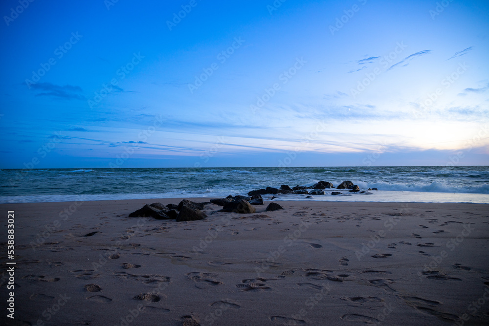 Long exposure by the sea with rocks in the sand, blue hour. Denmark beach Long exposure by the sea with rocks in the sand, blue hour. Denmark beach