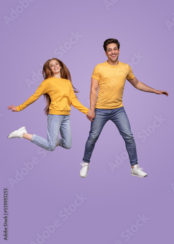 Happy young couple jumping together
