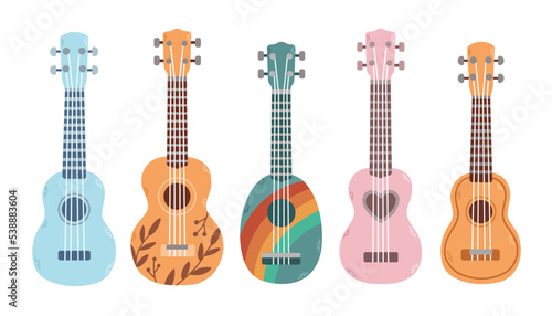 Set of ukulele in different colors and sizes. Popular music instrument. photo